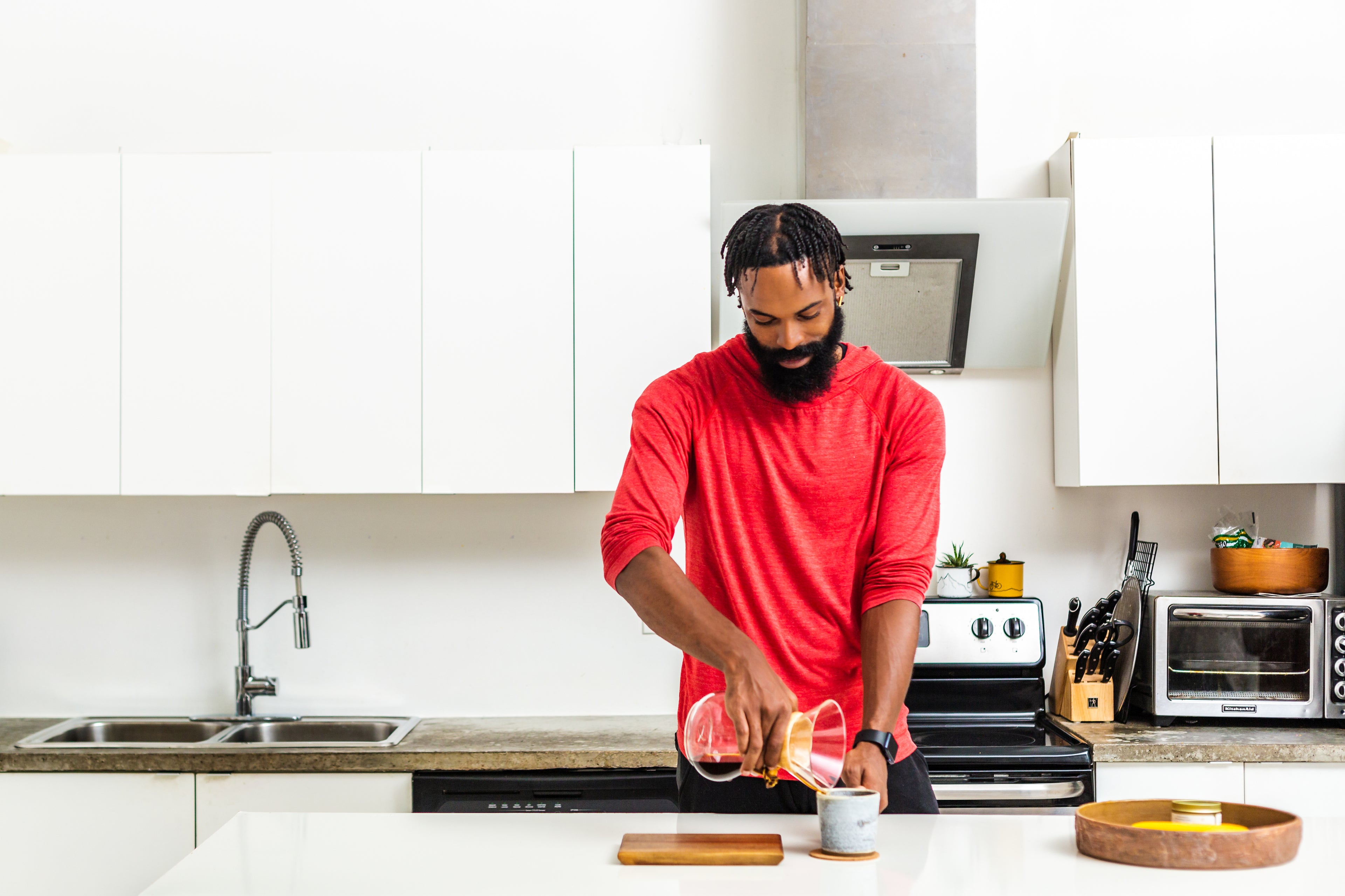 man-makes-pour-over-coffee-in-kitchen